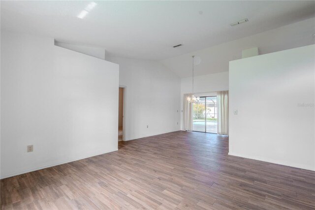 1838 Eagle Ridge Blvd, Palm Harbor, FL 34685 - spare room featuring a chandelier, wood finished floors, and high vaulted ceiling