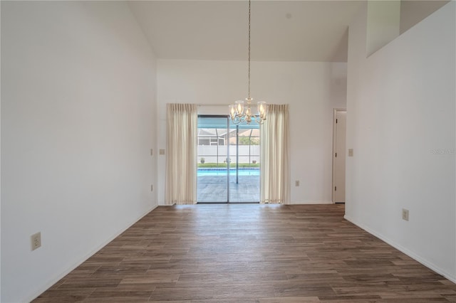 1838 Eagle Ridge Blvd, Palm Harbor, FL 34685 - unfurnished dining area with a towering ceiling, a chandelier, and dark wood-style flooring