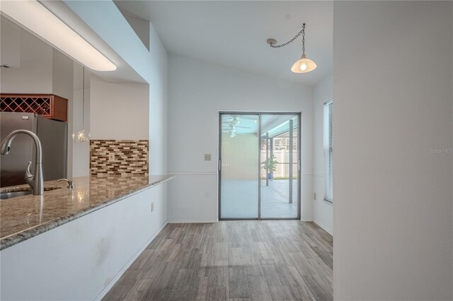 1838 Eagle Ridge Blvd, Palm Harbor, FL 34685 - unfurnished dining area with vaulted ceiling and wood finished floors