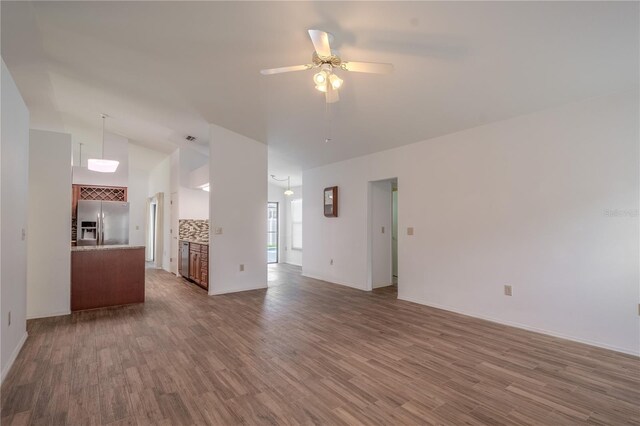 1838 Eagle Ridge Blvd, Palm Harbor, FL 34685 - unfurnished living room featuring wood finished floors, a ceiling fan, and high vaulted ceiling