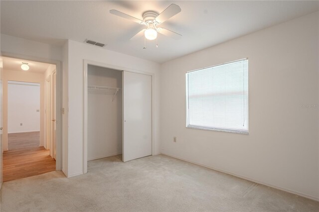 1838 Eagle Ridge Blvd, Palm Harbor, FL 34685 - unfurnished bedroom featuring light carpet, a closet, and ceiling fan