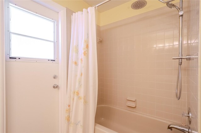 1838 Eagle Ridge Blvd, Palm Harbor, FL 34685 - bathroom featuring shower / bath combo with shower curtain