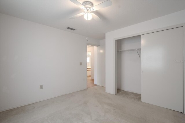 1838 Eagle Ridge Blvd, Palm Harbor, FL 34685 - unfurnished bedroom with a closet, light carpet, and ceiling fan
