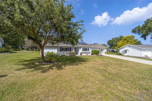8225 SW 108th Street Rd, Ocala, FL 34481 - single story home featuring solar panels, a porch, concrete driveway, and a front lawn