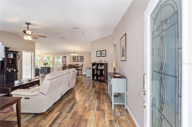 8225 SW 108th Street Rd, Ocala, FL 34481 - living area with dark wood-type flooring, a ceiling fan, a textured ceiling, a chandelier, and vaulted ceiling