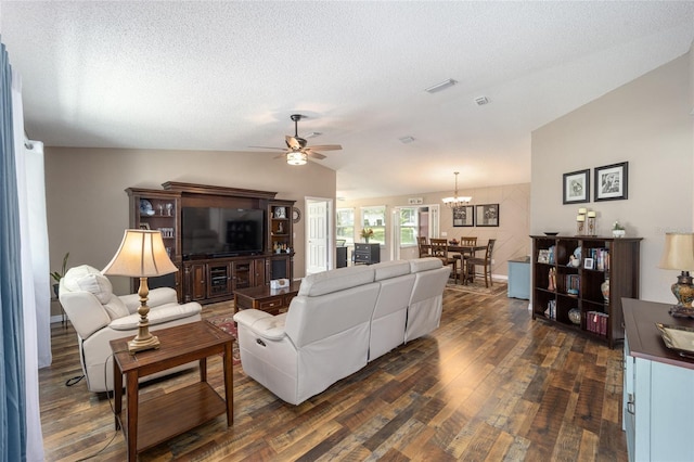 8225 SW 108th Street Rd, Ocala, FL 34481 - living area featuring lofted ceiling, dark wood-style flooring, ceiling fan, a chandelier, and a textured ceiling
