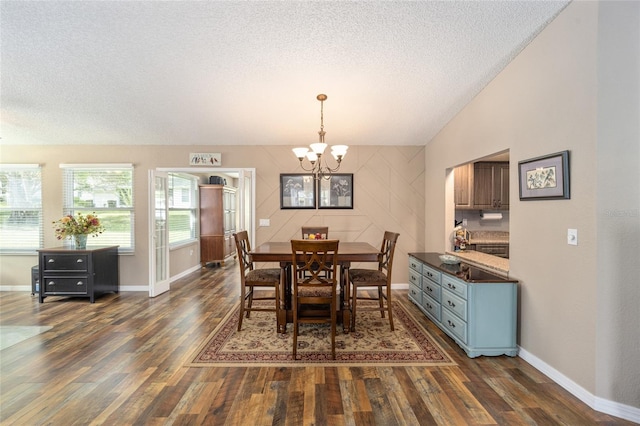 8225 SW 108th Street Rd, Ocala, FL 34481 - dining room with dark wood-style flooring, a textured ceiling, a chandelier, and baseboards