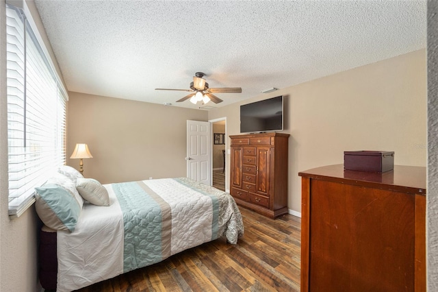 8225 SW 108th Street Rd, Ocala, FL 34481 - bedroom with dark wood-type flooring, a textured ceiling, and ceiling fan