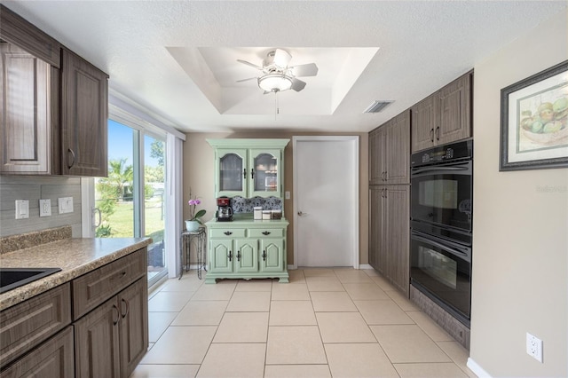 8225 SW 108th Street Rd, Ocala, FL 34481 - kitchen with backsplash, ceiling fan, a tray ceiling, and dark brown cabinetry