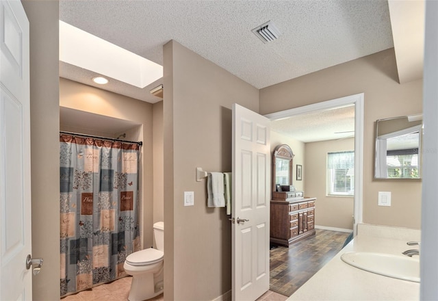 8225 SW 108th Street Rd, Ocala, FL 34481 - bathroom with toilet, vanity, a textured ceiling, a shower with shower curtain, and baseboards