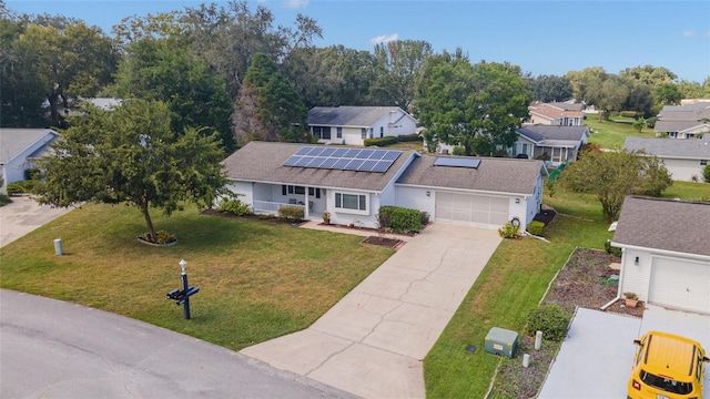 8225 SW 108th Street Rd, Ocala, FL 34481 - view of front of house featuring covered porch, roof mounted solar panels, a front lawn, and driveway