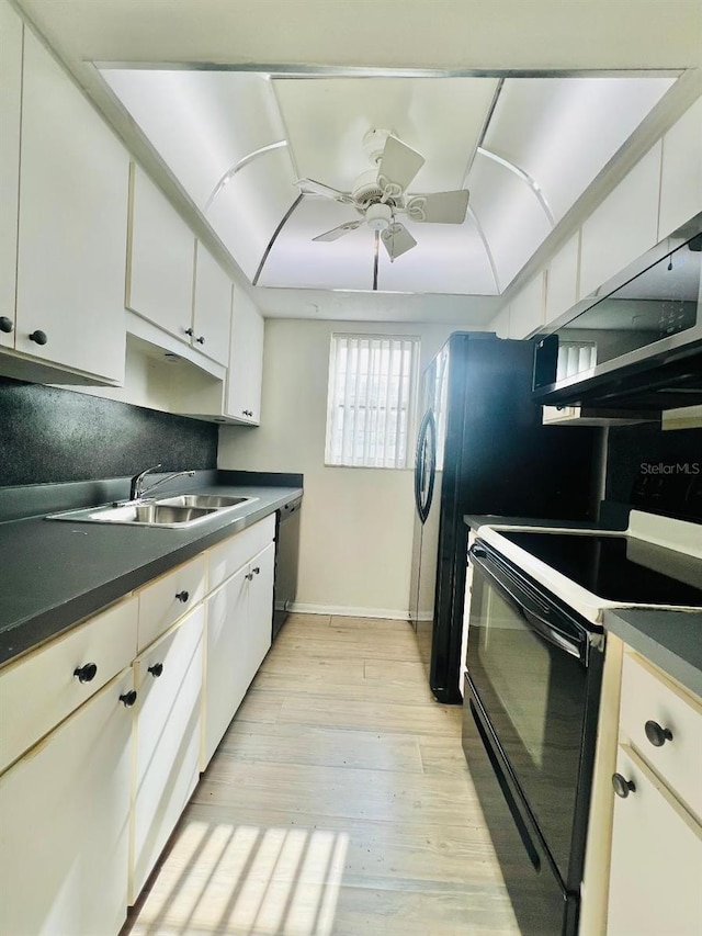 4611 W N B St Unit 125, Tampa, FL 33609 - kitchen featuring appliances with stainless steel finishes, a sink, dark countertops, and white cabinetry