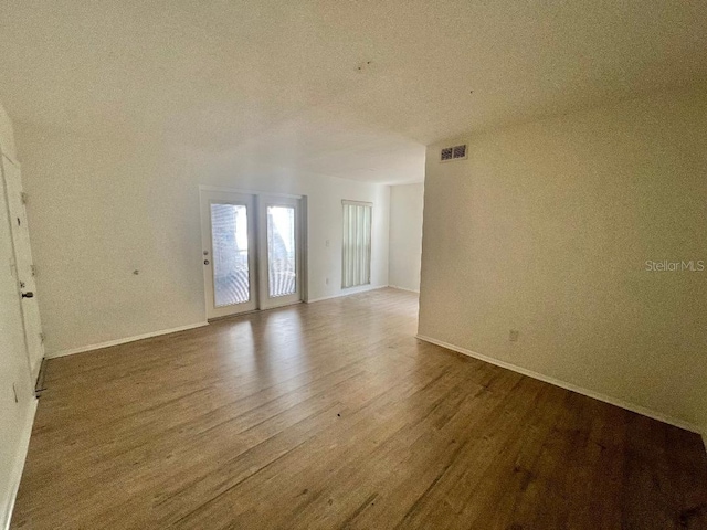 4611 W N B St Unit 125, Tampa, FL 33609 - spare room featuring wood finished floors and baseboards