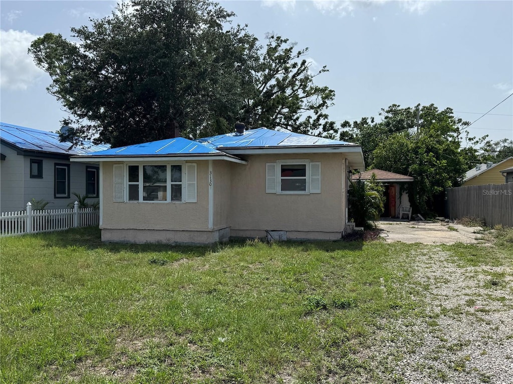 3130 19th St N, Saint Petersburg, FL 33713 - view of side of property featuring metal roof and stucco siding