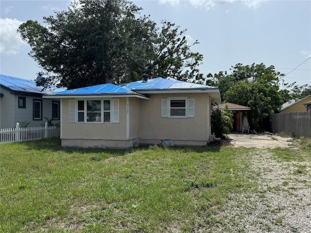 3130 19th St N, Saint Petersburg, FL 33713 - view of side of property featuring metal roof and stucco siding