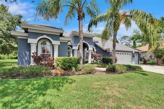 27440 Cedar Park Ct, Wesley Chapel, FL 33544 - view of front facade featuring stucco siding, an attached garage, a front lawn, and concrete driveway
