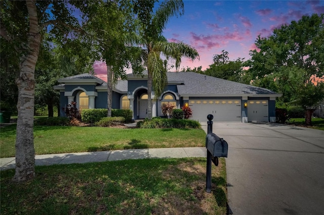 27440 Cedar Park Ct, Wesley Chapel, FL 33544 - view of front of home with an attached garage, driveway, a front lawn, and stucco siding