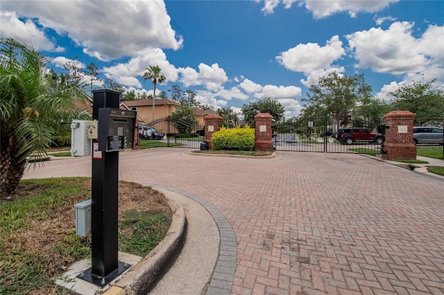 27440 Cedar Park Ct, Wesley Chapel, FL 33544 - view of decorative road featuring a gate, curbs, and a gated entry
