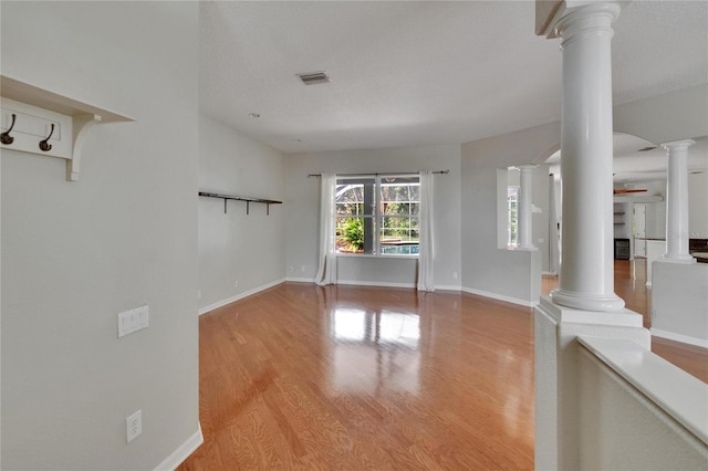 27440 Cedar Park Ct, Wesley Chapel, FL 33544 - spare room with decorative columns, ceiling fan, wood finished floors, and baseboards