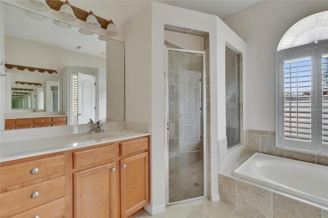 27440 Cedar Park Ct, Wesley Chapel, FL 33544 - bathroom with vanity, a stall shower, a garden tub, and tile patterned flooring