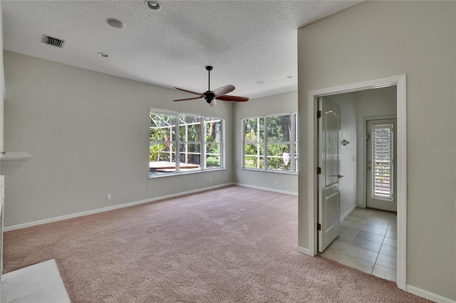 27440 Cedar Park Ct, Wesley Chapel, FL 33544 - empty room with light carpet, ceiling fan, a textured ceiling, and baseboards