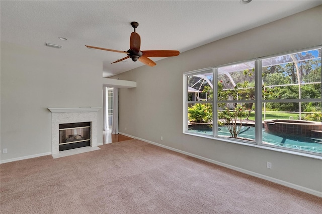 27440 Cedar Park Ct, Wesley Chapel, FL 33544 - unfurnished living room featuring carpet, a ceiling fan, a fireplace with flush hearth, and baseboards