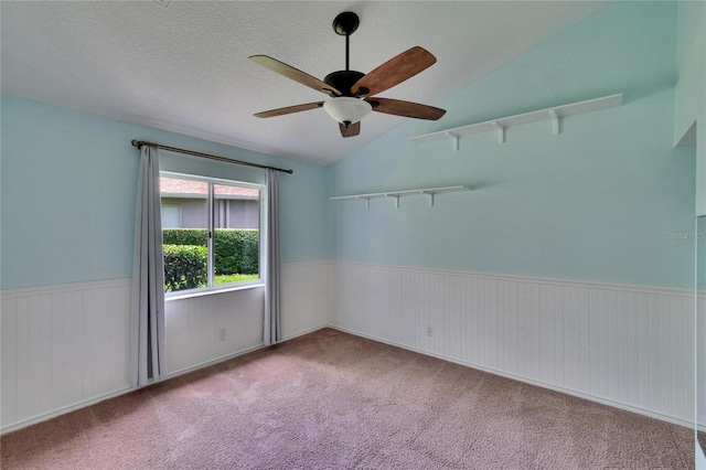 27440 Cedar Park Ct, Wesley Chapel, FL 33544 - empty room with wainscoting, ceiling fan, lofted ceiling, and carpet floors