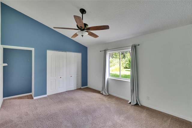 27440 Cedar Park Ct, Wesley Chapel, FL 33544 - unfurnished bedroom with carpet floors, vaulted ceiling, a closet, a ceiling fan, and baseboards