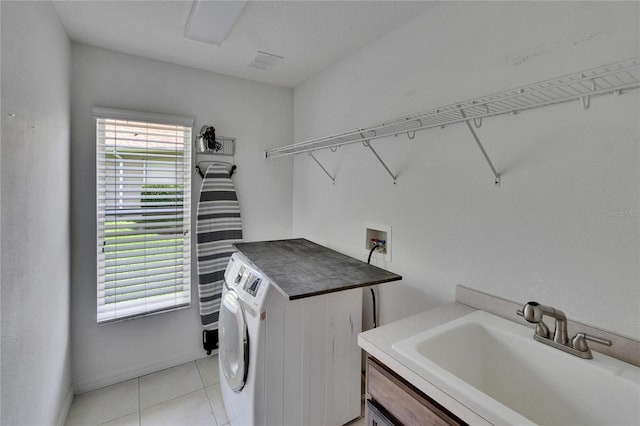 27440 Cedar Park Ct, Wesley Chapel, FL 33544 - washroom featuring washer / dryer, light tile patterned floors, and baseboards