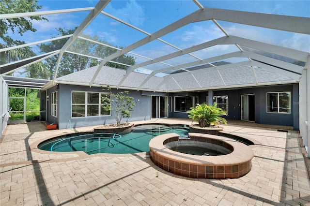 27440 Cedar Park Ct, Wesley Chapel, FL 33544 - view of swimming pool featuring glass enclosure, a pool with connected hot tub, and a patio