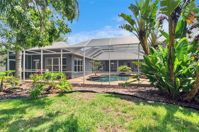 27440 Cedar Park Ct, Wesley Chapel, FL 33544 - back of house featuring glass enclosure, an outdoor pool, and a patio area
