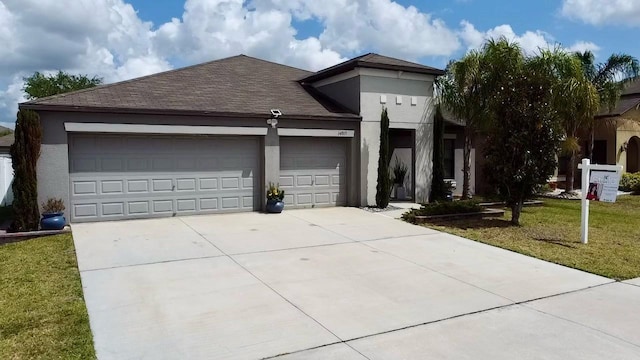 14015 Arbor Pines Dr, Riverview, FL 33579 - view of front of property with stucco siding, concrete driveway, an attached garage, a front lawn, and a shingled roof