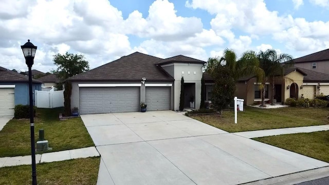 14015 Arbor Pines Dr, Riverview, FL 33579 - view of front of house featuring an attached garage, stucco siding, driveway, and roof with shingles