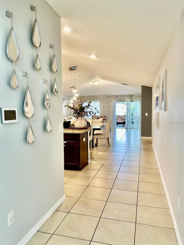 14015 Arbor Pines Dr, Riverview, FL 33579 - hall with light tile patterned floors, vaulted ceiling, and baseboards