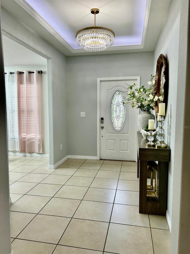 14015 Arbor Pines Dr, Riverview, FL 33579 - foyer entrance featuring a raised ceiling, a chandelier, light tile patterned flooring, and baseboards