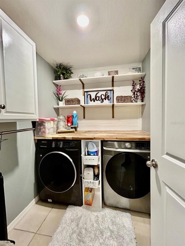 14015 Arbor Pines Dr, Riverview, FL 33579 - laundry area with cabinet space, separate washer and dryer, light tile patterned floors, and baseboards