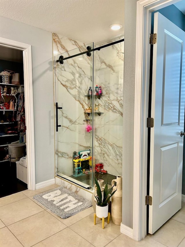 14015 Arbor Pines Dr, Riverview, FL 33579 - full bath with a marble finish shower, tile patterned floors, a textured ceiling, and a spacious closet