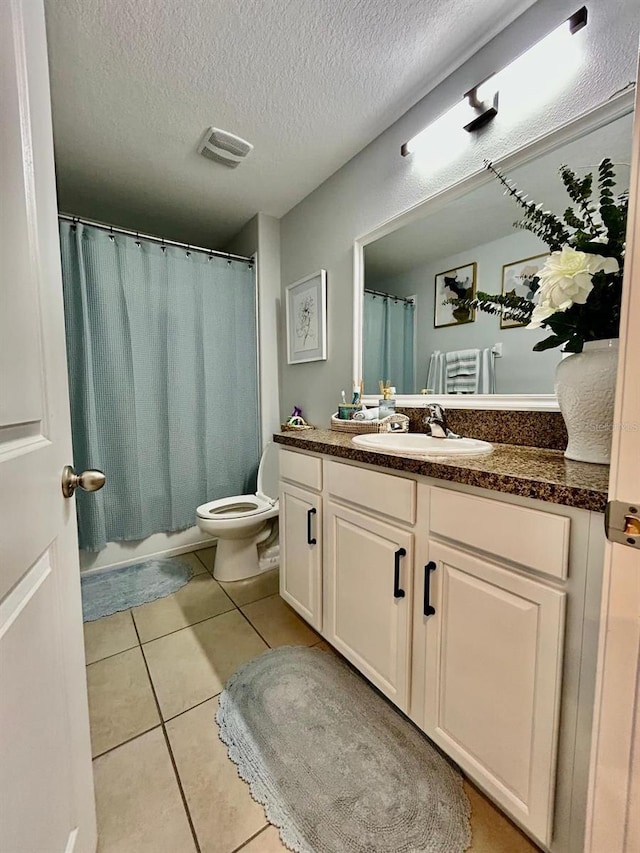 14015 Arbor Pines Dr, Riverview, FL 33579 - full bath with vanity, toilet, tile patterned flooring, a textured ceiling, and a shower with shower curtain