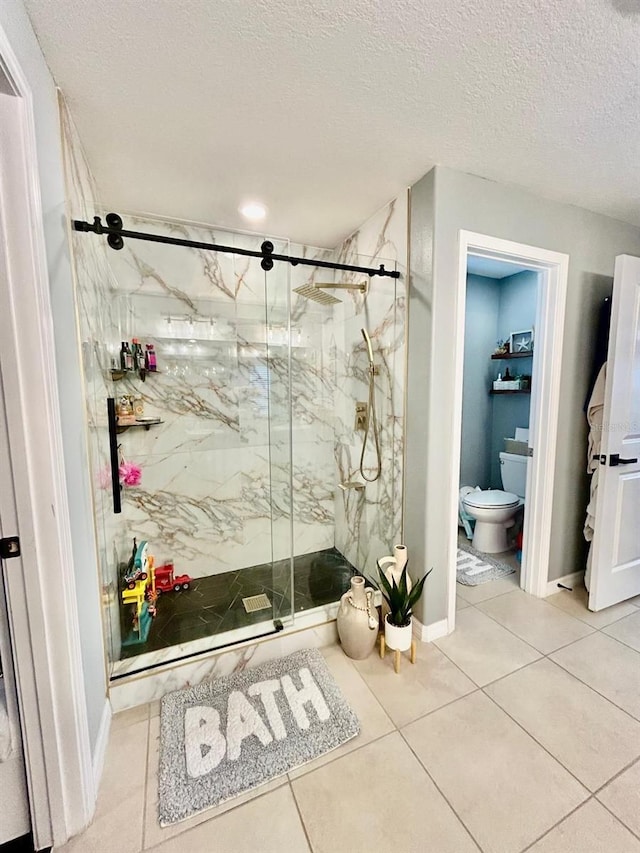 14015 Arbor Pines Dr, Riverview, FL 33579 - full bathroom featuring a marble finish shower, toilet, tile patterned floors, baseboards, and a textured ceiling