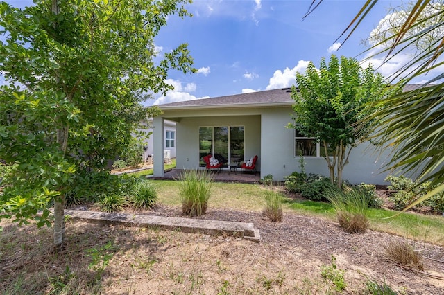 1890 Flora Pass Pl, Kissimmee, FL 34747 - rear view of house featuring stucco siding and a patio area