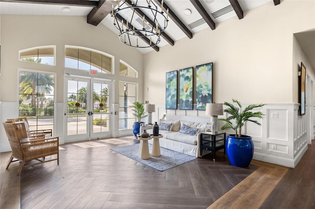1890 Flora Pass Pl, Kissimmee, FL 34747 - living room with french doors, a chandelier, beam ceiling, high vaulted ceiling, and a wainscoted wall