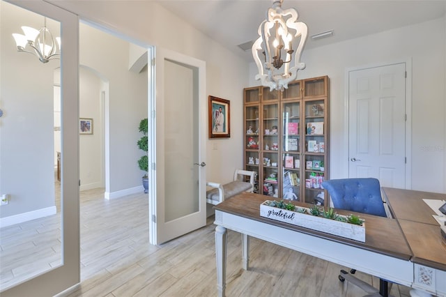 6016 Shadowlake Dr, Apollo Beach, FL 33572 - home office with a chandelier, arched walkways, light wood-type flooring, baseboards, and french doors