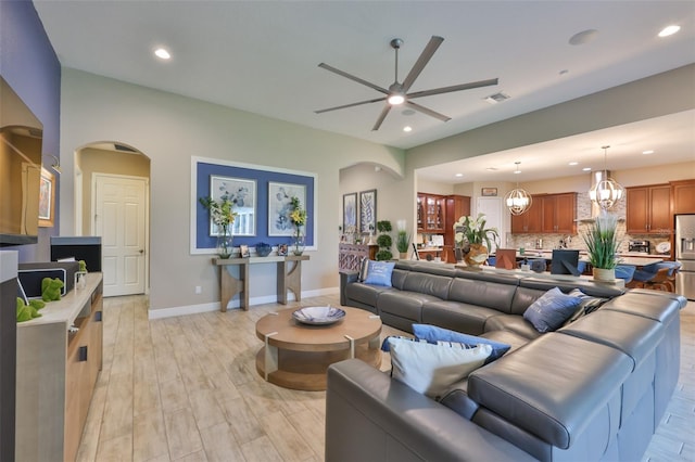 6016 Shadowlake Dr, Apollo Beach, FL 33572 - living room featuring ceiling fan, recessed lighting, arched walkways, baseboards, and light wood-style floors