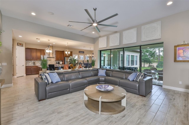 6016 Shadowlake Dr, Apollo Beach, FL 33572 - living area featuring ceiling fan, recessed lighting, baseboards, a chandelier, and light wood-style floors