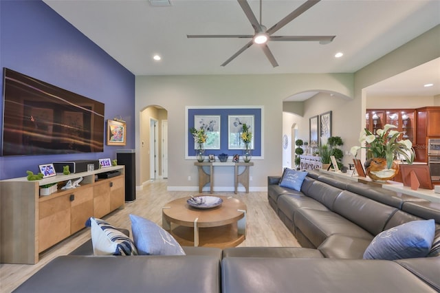 6016 Shadowlake Dr, Apollo Beach, FL 33572 - living room featuring arched walkways, a ceiling fan, light wood-style floors, recessed lighting, and baseboards