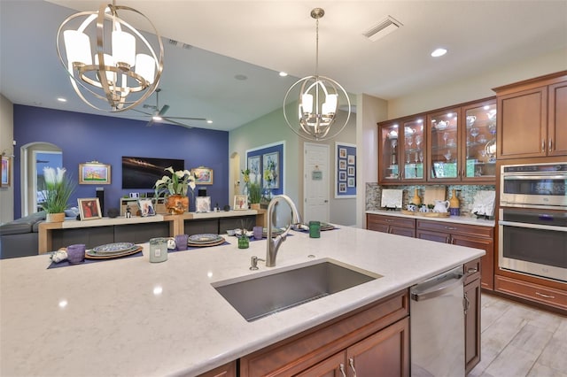 6016 Shadowlake Dr, Apollo Beach, FL 33572 - kitchen with a chandelier, a sink, open floor plan, appliances with stainless steel finishes, and pendant lighting