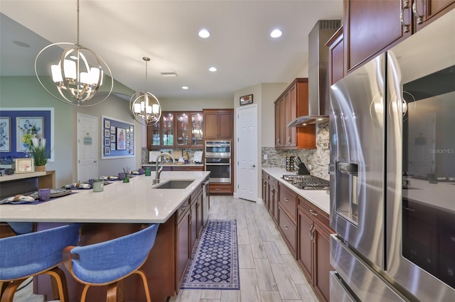 6016 Shadowlake Dr, Apollo Beach, FL 33572 - kitchen with a sink, stainless steel appliances, a chandelier, tasteful backsplash, and an island with sink