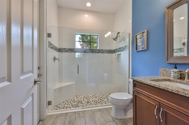 6016 Shadowlake Dr, Apollo Beach, FL 33572 - full bath with vanity, a stall shower, toilet, and wood finished floors