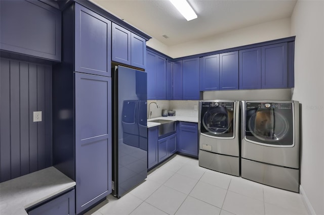 6016 Shadowlake Dr, Apollo Beach, FL 33572 - laundry area with cabinet space, washer and clothes dryer, and light tile patterned floors