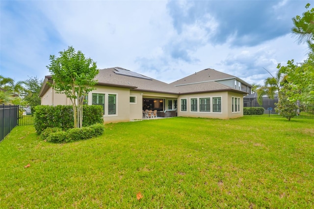 6016 Shadowlake Dr, Apollo Beach, FL 33572 - rear view of property with stucco siding, roof mounted solar panels, and a patio area